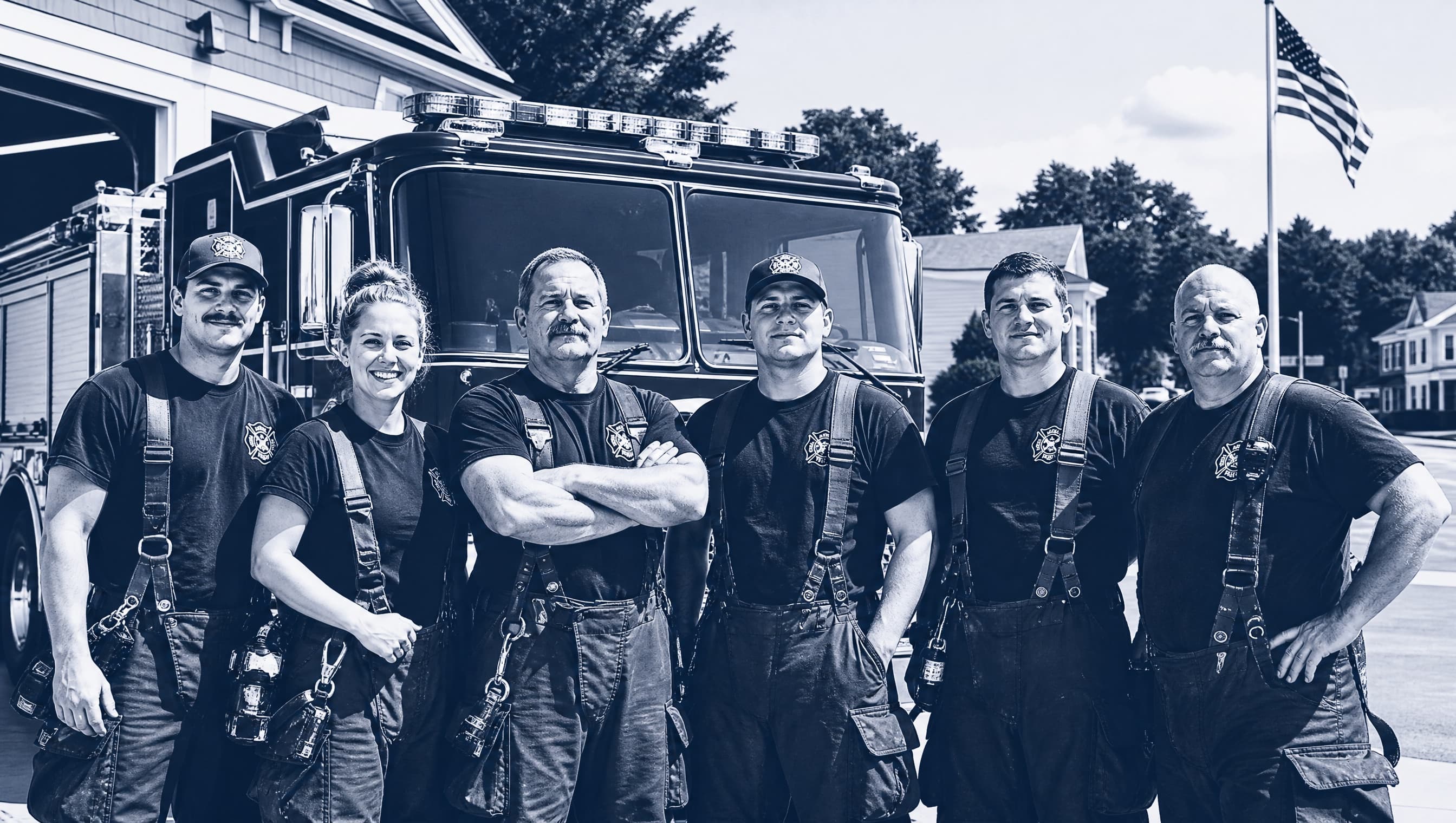 Volunteer fire crew in front of their engine, navy duotone